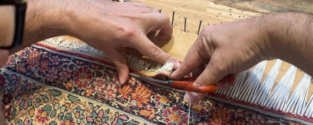 Retissage des franges d'un tapis