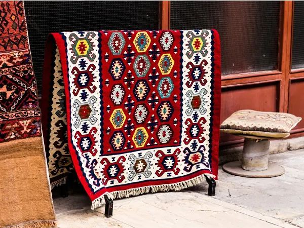 Comment reconnaître la qualité d’un tapis iranien avant d’en acheter ? exposition tapis orient rouge marche